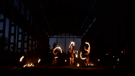 A-group-of-professional-artists-with-fire-show-the-show-juggling-and-dancing-with-fire-in-slow-motion